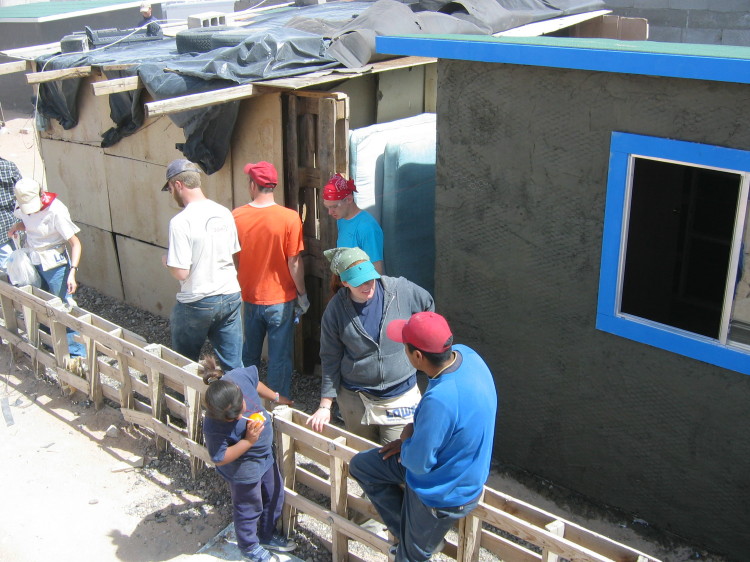 Image 110 of 168
lunchtime on workday 3 (Wednesday), first layer of stucco up, jess talks with jose